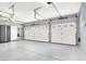 This large garage boasts epoxy floors, overhead lighting, and storage for multiple vehicles at 2102 Rhonda Ter, Henderson, NV 89074