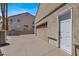 Attached garage with a white entry door adjacent to the roll-up garage door at 2102 Rhonda Ter, Henderson, NV 89074