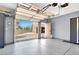 Garage view showcasing an open overhead door, epoxy flooring, and ample storage space at 2102 Rhonda Ter, Henderson, NV 89074