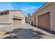 Spacious driveway leading to two garages with roll-up doors, perfect for car enthusiasts at 2102 Rhonda Ter, Henderson, NV 89074