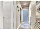 Neutral hallway featuring modern lighting, a blue accent door, and decorative area rug at 2102 Rhonda Ter, Henderson, NV 89074