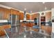Well-lit kitchen with stainless steel appliances and granite countertops, perfect for cooking and entertaining at 2102 Rhonda Ter, Henderson, NV 89074