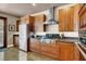 Modern kitchen featuring stainless steel appliances, custom cabinets, and a gas cooktop with stainless vent hood at 2102 Rhonda Ter, Henderson, NV 89074