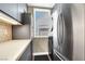 Efficient laundry room with modern appliances, overhead cabinets, and stylish backsplash at 2102 Rhonda Ter, Henderson, NV 89074