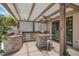 Elegant outdoor kitchen with stone accents, stainless steel appliances, bar seating, and ample counter space at 2102 Rhonda Ter, Henderson, NV 89074