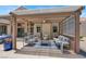 Cozy covered patio with comfortable seating around a fire pit table, perfect for outdoor relaxation at 2102 Rhonda Ter, Henderson, NV 89074