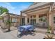 Picturesque backyard patio with a dining area, outdoor kitchen, and mature landscaping creating an inviting space at 2102 Rhonda Ter, Henderson, NV 89074