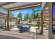 Inviting covered patio with string lights, dining set, and comfortable outdoor seating area at 2102 Rhonda Ter, Henderson, NV 89074