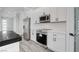 Bright kitchen featuring stainless steel appliances, white cabinets, and a pantry at 2110 S Manzanita Dr, Pahrump, NV 89048