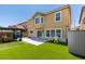 Backyard of a two-story home with an artificial turf yard, pergola, and storage shed at 212 Stagecoach Flats, Las Vegas, NV 89031