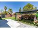 Backyard featuring a built-in pergola-covered lounge area on artificial turf and privacy wall at 212 Stagecoach Flats, Las Vegas, NV 89031