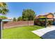 Wide shot of a backyard featuring artificial turf, privacy wall and a built-in pergola-covered lounge area at 212 Stagecoach Flats, Las Vegas, NV 89031