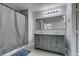 Beautiful bathroom featuring a double vanity with a large framed mirror and tub/shower combo at 212 Stagecoach Flats, Las Vegas, NV 89031