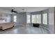 Spacious main bedroom featuring light gray walls, wood look floors, ceiling fan and several sunny windows at 212 Stagecoach Flats, Las Vegas, NV 89031