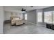 Spacious main bedroom featuring light gray walls, wood look floors, ceiling fan and several sunny windows at 212 Stagecoach Flats, Las Vegas, NV 89031