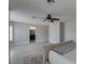 Spacious main bedroom featuring light gray walls, wood look floors, ceiling fan and several sunny windows at 212 Stagecoach Flats, Las Vegas, NV 89031