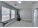 Bright bonus room with gray walls, wood look floors, and large windows is a versatile space at 212 Stagecoach Flats, Las Vegas, NV 89031
