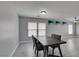 Modern dining room with gray walls, a wood table, and large windows at 212 Stagecoach Flats, Las Vegas, NV 89031
