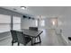Dining area with grey walls, laminate flooring, large windows, and modern table and chairs at 212 Stagecoach Flats, Las Vegas, NV 89031