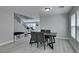 Open dining area with iron staircase and grey vinyl flooring with table and chairs at 212 Stagecoach Flats, Las Vegas, NV 89031