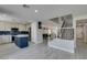 Modern kitchen featuring an island, stainless steel appliances, and access to staircase at 212 Stagecoach Flats, Las Vegas, NV 89031