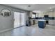 Bright kitchen featuring an island, stainless steel appliances, and glass sliding door access to the outside at 212 Stagecoach Flats, Las Vegas, NV 89031