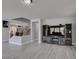 Bright living room with entertainment center, wood laminate flooring, and staircase access at 212 Stagecoach Flats, Las Vegas, NV 89031