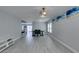 Open-concept living space with laminate floors, dining area, and staircase to the second level at 212 Stagecoach Flats, Las Vegas, NV 89031
