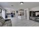 Open-concept living space featuring modern flooring, stainless kitchen appliances and access to the staircase at 212 Stagecoach Flats, Las Vegas, NV 89031