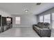 Living room showcases modern entertainment center, gray couch, and natural light at 212 Stagecoach Flats, Las Vegas, NV 89031