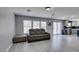 Open-concept living space featuring gray couch and sliding glass doors at 212 Stagecoach Flats, Las Vegas, NV 89031