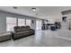 Open-concept living space with gray couch and partial view of kitchen at 212 Stagecoach Flats, Las Vegas, NV 89031