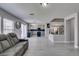 Spacious living room featuring modern flooring, neutral paint, and access to the kitchen and staircase at 212 Stagecoach Flats, Las Vegas, NV 89031