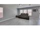 Comfortable living area with a large gray sofa and bright windows at 212 Stagecoach Flats, Las Vegas, NV 89031