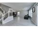 Spacious living room featuring staircase, gray couch, and ample natural light at 212 Stagecoach Flats, Las Vegas, NV 89031