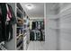 A large walk-in closet with ample storage including shelving, drawers, and hanging space for clothes and accessories at 212 Stagecoach Flats, Las Vegas, NV 89031