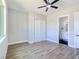 This bedroom has hard wood floors, ceiling fan, ensuite bathroom and closet at 2150 S Manzanita Dr, Pahrump, NV 89048