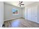 Comfortable bedroom features wood-look flooring, closet with sliding doors, and ample natural light at 2150 S Manzanita Dr, Pahrump, NV 89048