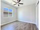 Neutral bedroom features wood-look flooring, closet with sliding doors, and ample natural light at 2150 S Manzanita Dr, Pahrump, NV 89048