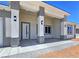 The entryway shows the pillars with wall lighting and a front door with sidelight windows at 2150 S Manzanita Dr, Pahrump, NV 89048