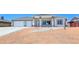 Charming single-story home featuring desert landscaping, a two-car garage, and a modern architectural design at 2150 S Manzanita Dr, Pahrump, NV 89048