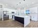 Gourmet kitchen with island, stainless steel appliances, white subway tile backsplash, and pendant lights at 2150 S Manzanita Dr, Pahrump, NV 89048