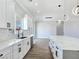 Contemporary kitchen with white cabinets, quartz countertops, and stainless steel appliances at 2150 S Manzanita Dr, Pahrump, NV 89048