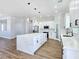Well-lit kitchen boasts an island with quartz countertops, stainless steel appliances, and ample cabinet space at 2150 S Manzanita Dr, Pahrump, NV 89048