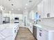 Bright kitchen featuring white cabinets, subway tile backsplash, and stainless steel appliances at 2150 S Manzanita Dr, Pahrump, NV 89048