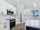 Elegant kitchen with quartz countertops, stainless steel appliances, and ample cabinet storage at 2150 S Manzanita Dr, Pahrump, NV 89048