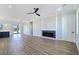 Spacious living room features stylish wood floors, a modern fireplace, and a ceiling fan at 2150 S Manzanita Dr, Pahrump, NV 89048