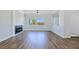 Spacious living room with hardwood floors, a modern fireplace, and a view of the exterior at 2150 S Manzanita Dr, Pahrump, NV 89048
