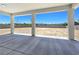 Covered patio with concrete flooring looks out onto a large, private, fenced backyard at 2150 S Manzanita Dr, Pahrump, NV 89048