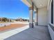 Spacious covered porch with decorative pillars and recessed lighting overlooking the front yard at 2150 S Manzanita Dr, Pahrump, NV 89048
